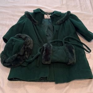 Hunter green jacket, hat, and muff.